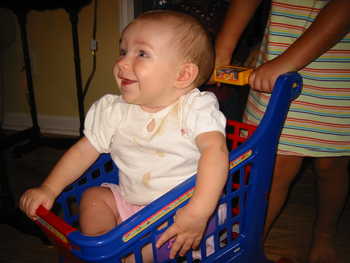 Malia smiles from the shopping cart